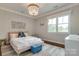 Bright bedroom with large window, hardwood floors, and elegant chandelier at 421 Mcdonald Ave, Charlotte, NC 28203