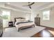 Serene bedroom with tray ceilings, patterned wallpaper, hardwood floors, and ample natural light, ensuring comfort at 421 Mcdonald Ave, Charlotte, NC 28203