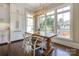 Sunlit dining area with large windows, stylish light fixture, and a farmhouse-style dining table at 421 Mcdonald Ave, Charlotte, NC 28203