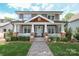 Charming two-story home with a welcoming front porch, lush lawn and beautiful landscaping at 421 Mcdonald Ave, Charlotte, NC 28203