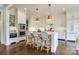 Bright kitchen with white cabinets, stainless appliances, island with breakfast bar, and hardwood floors at 421 Mcdonald Ave, Charlotte, NC 28203