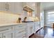 Elegant kitchen featuring sleek white cabinetry, subway tile backsplash, stone countertops and high-end appliances at 421 Mcdonald Ave, Charlotte, NC 28203