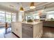Open kitchen with a large island, farm sink, stainless steel dishwasher, and open layout to living spaces at 421 Mcdonald Ave, Charlotte, NC 28203