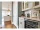 Wet bar area with wine storage, white cabinets, and stylish backsplash, offering a convenient entertaining space at 421 Mcdonald Ave, Charlotte, NC 28203