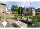 Paver patio with ample seating, a modern fire pit table, and a landscaped garden backdrop at 421 Mcdonald Ave, Charlotte, NC 28203