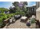 Outdoor patio with pavers, built-in seating, decorative plants, and a modern fire pit table at 421 Mcdonald Ave, Charlotte, NC 28203