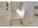 Luxurious all-marble walk-in shower with bench seat, rainfall shower head, and shower products at 421 Mcdonald Ave, Charlotte, NC 28203