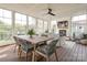 Bright sunroom with wood floors, brick fireplace, ceiling fan, dining table, and comfortable seating area at 421 Mcdonald Ave, Charlotte, NC 28203