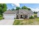 Single-story home with a covered porch, attached garage and a well-maintained lawn at 4949 Southview Dr, Hickory, NC 28602