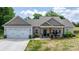 Attractive one-story home featuring a covered porch, two-car garage, and fresh landscaping at 4949 Southview Dr, Hickory, NC 28602