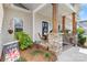 Cozy covered porch with stone columns and charming outdoor seating at 4949 Southview Dr, Hickory, NC 28602