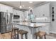 Modern kitchen featuring white cabinets, granite countertops, stainless steel appliances, and a functional kitchen island with seating at 4949 Southview Dr, Hickory, NC 28602