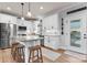 Modern kitchen featuring white cabinets, granite countertops, stainless steel appliances, and a functional kitchen island with seating at 4949 Southview Dr, Hickory, NC 28602