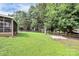 Large grassy backyard with a wooden fence and mature trees at 5601 Carmel Station Ave, Charlotte, NC 28226