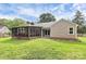 Home featuring a screened-in porch and a grassy backyard at 5601 Carmel Station Ave, Charlotte, NC 28226