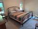 Cozy bedroom with a comfortable bed, soft carpet, and plenty of natural light at 5601 Carmel Station Ave, Charlotte, NC 28226