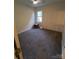 Bedroom with neutral carpet, light walls, and a ceiling fan at 5601 Carmel Station Ave, Charlotte, NC 28226
