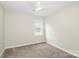 Cozy bedroom with neutral walls, ceiling fan, and carpeted floor at 5601 Carmel Station Ave, Charlotte, NC 28226