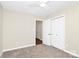 Bright bedroom featuring a closet and a doorway with hardwood floors visible at 5601 Carmel Station Ave, Charlotte, NC 28226