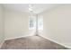 Neutral bedroom with carpeted floors and natural light from two windows at 5601 Carmel Station Ave, Charlotte, NC 28226
