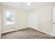 Light-filled bedroom with carpet, a ceiling fan, and a large window at 5601 Carmel Station Ave, Charlotte, NC 28226
