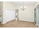 Bright dining area with hardwood floors, chandelier and sliding glass doors at 5601 Carmel Station Ave, Charlotte, NC 28226