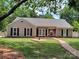 Charming single-story home with a well-manicured lawn, brick walkway, and neutral siding at 5601 Carmel Station Ave, Charlotte, NC 28226
