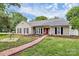Charming ranch-style home with a red brick walkway, manicured lawn, and inviting curb appeal at 5601 Carmel Station Ave, Charlotte, NC 28226