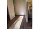 Bright hallway featuring wood-look flooring, white trim, and neutral paint at 5601 Carmel Station Ave, Charlotte, NC 28226