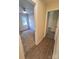Hallway leading to a bedroom, featuring wood-look flooring and neutral paint at 5601 Carmel Station Ave, Charlotte, NC 28226