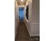 Inviting hallway features hardwood floors, and neutral paint, leading to various rooms at 5601 Carmel Station Ave, Charlotte, NC 28226