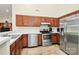 Well-equipped kitchen with stainless steel appliances, wooden cabinets, and laminate countertops at 5601 Carmel Station Ave, Charlotte, NC 28226