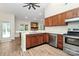 Open concept kitchen with stainless steel dishwasher and dark wooden cabinets at 5601 Carmel Station Ave, Charlotte, NC 28226