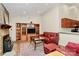 Cozy living room features a brick fireplace, hardwood floors, and a comfortable red leather sofa set at 5601 Carmel Station Ave, Charlotte, NC 28226