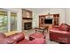 Cozy living room featuring a brick fireplace, display shelving, and comfortable seating at 5601 Carmel Station Ave, Charlotte, NC 28226