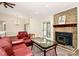 Comfortable living room with fireplace, glass coffee table, and an area rug at 5601 Carmel Station Ave, Charlotte, NC 28226