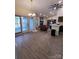 Open living space with sliding doors, wood-look flooring, and a modern ceiling fan at 5601 Carmel Station Ave, Charlotte, NC 28226