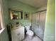 Full bathroom with a white vanity, framed mirror, toilet and walk-in shower at 5938 Sharon Rd, Charlotte, NC 28210