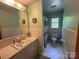 Full bathroom featuring a sink, mirror, toilet, tiled floor and shower with curtain at 5938 Sharon Rd, Charlotte, NC 28210