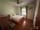 Cozy bedroom featuring hardwood floors, natural light, and ceiling fan at 5938 Sharon Rd, Charlotte, NC 28210