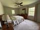 Bedroom with neutral carpet, ceiling fan, and a door providing easy access to the backyard at 5938 Sharon Rd, Charlotte, NC 28210
