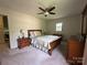 Bedroom with neutral carpet, ceiling fan, and a door providing easy access to the backyard at 5938 Sharon Rd, Charlotte, NC 28210