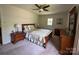 Bedroom features a wooden bed frame, neutral walls, and a door to the exterior at 5938 Sharon Rd, Charlotte, NC 28210
