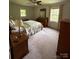 Bedroom with neutral carpet, ceiling fan, and a door providing easy access to the backyard at 5938 Sharon Rd, Charlotte, NC 28210