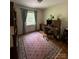 Bedroom with a large window, hardwood floors, and an area rug, perfect for a home office at 5938 Sharon Rd, Charlotte, NC 28210