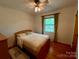 Bright bedroom featuring a bed, hardwood floors, and a window with abundant natural light at 5938 Sharon Rd, Charlotte, NC 28210