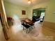 Inviting dining area with light-colored walls, neutral carpet, and a clear view into the adjacent living room at 5938 Sharon Rd, Charlotte, NC 28210