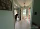 Bright hallway leads to living area with large windows and open doorway at 5938 Sharon Rd, Charlotte, NC 28210