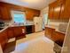 Traditional kitchen with wood cabinets, tile floors, and a window with natural light at 5938 Sharon Rd, Charlotte, NC 28210