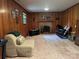 Wood paneled walls and a brick fireplace highlight this carpeted living room at 5938 Sharon Rd, Charlotte, NC 28210